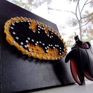 A 6x6 string art frame showcasing the iconic Batman symbol in vibrant threads.